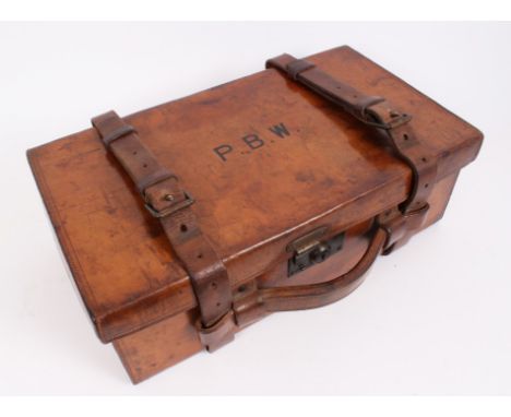 Edwardian leather cartridge magazine by Army & Navy with six divisions, brass lock and leather straps, initials to lid P.B.W.