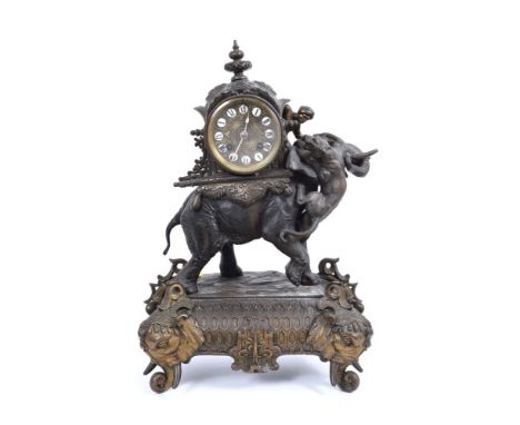 Late 19th century French gilt and bronzed spelter mantel clock in ornate case with lion attacking an Indian elephant with mah