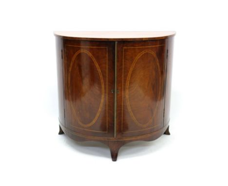 Regency mahogany and inlaid demi-lune side cabinet with shelved interior, enclosed by pair of oval inlaid cupboard doors with