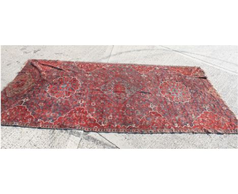 Rare early Turkish carpet fragment, blood-red field centred by foliate and lozenge medallions within busy repeat flower-head 