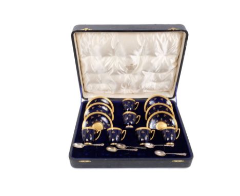Set of six Edwardian Coalport coffee cups and saucers with gilt floral sprays on blue ground and gilt borders, in original fi