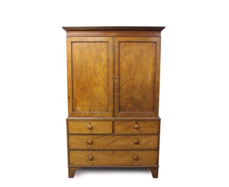 George IV mahogany linen press with reel moulded cavetto cornice and interior of shelves and three short drawers enclosed by 