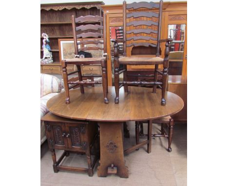 A 20th century oak gateleg dining table together with a set of four ladder back dining chairs and an oak side cabinet