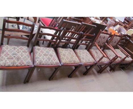 A set of four oak ladder back dining chairs together with a pair of elbow chairs and a rocking chair