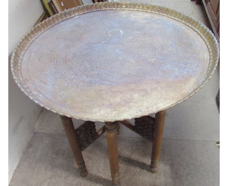 A brass tray top table with a Celtic pattern on a folding base together with a copper picture, Portuguese tiled picture and a