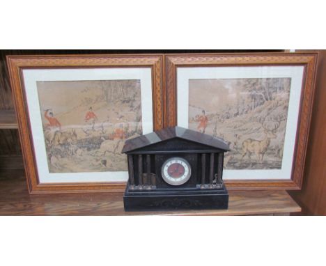 A black slate mantle clock of architectural form with three ionic columns, the circular dial with Arabic numerals and a plint