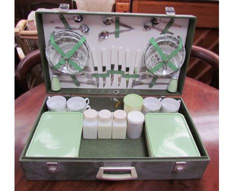 A Brexton picnic basket, with pottery plates, cups and saucers, with Tupperware boxes, in green together with a Blaeu wall ma