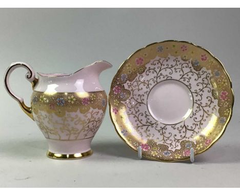 TUSCAN TEA SERVICE, decorated with flowers in pink, blue and yellow enamels on a gilt and pink ground, comprising twelve cups