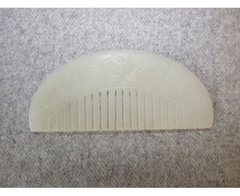 Chinese pale jade comb of demi lune form with foliate carving, 10cm L