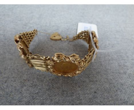 Sovereign mounted 9ct gold bracelet of fancy eight bar gate link design to a padlock clasp mounted with 3 sovereigns dated 18