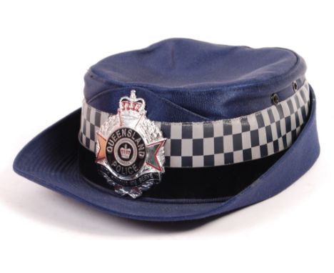 A rare 20th / 21st Century Australian Queensland female police cap / hat in blue with plastic black band and chequered reflec