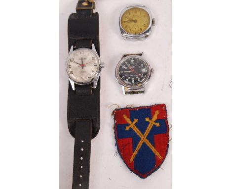A collection of assorted original WWII Second World War and related uniform cloth patches, cap badges and wristwatches. Cloth