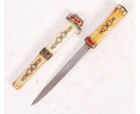 An unusual 20th Century decorated Moroccan dagger having a bone and brass hilt with engraved design, straight double edged bl