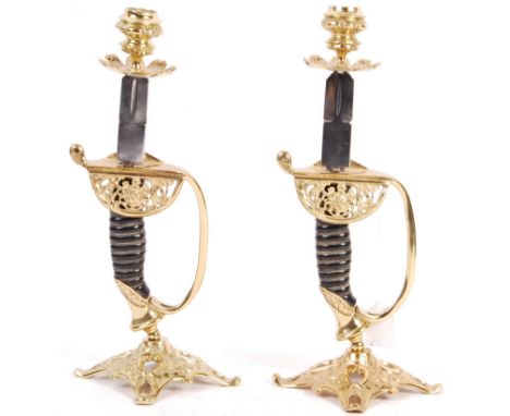 A pair of unusual WWI First World War German Imperial Army style cavalry sword handles fashioned into candlesticks with decor
