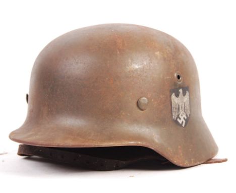 An incredible original WWII Second World War Third Reich Nazi German Army issued M35 Stahlhelm Q62 steel combat helmet libera
