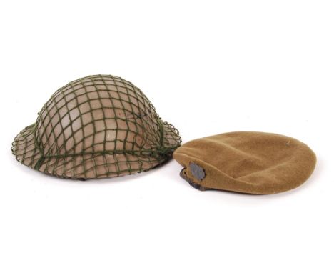 A rare original WWII Second World War London Scottish regiment badged beret, and associated steel Brodie helmet with netting.