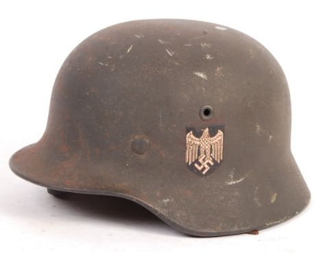 An original WWII Second World War Third Reich Nazi German Army Stahlhelm M35 steel combat helmet. Single-decal version. Rim s