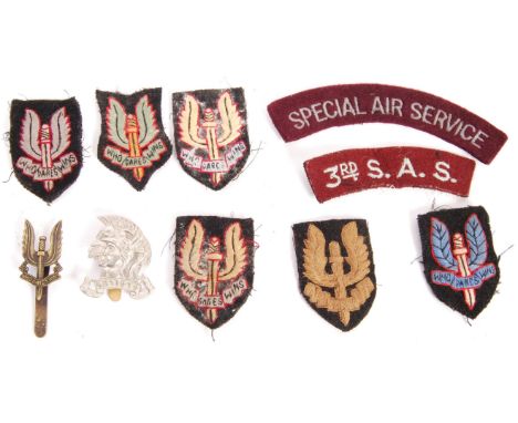 A good collection of original WWII Second World War era SAS Special Air Service uniform cloth patches, titles and cap badges.