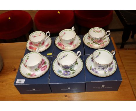 Six boxed Royal Kendall cups and saucers decorated with months of the year