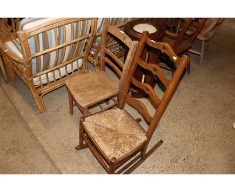 An elm seated bar back chair and a ladder back rocking chair 