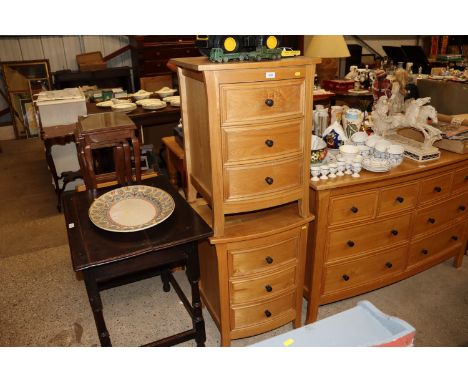 A pair of light oak bedside chests fitted three drawers 