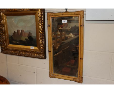A cane framed oblong wall mirror 