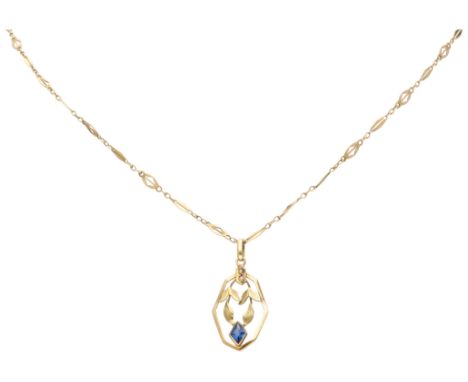 Art Deco 14K yellow gold pendant on a necklace with synthetic sapphire. Pendant with mistletoe leaves and two seed pearls and