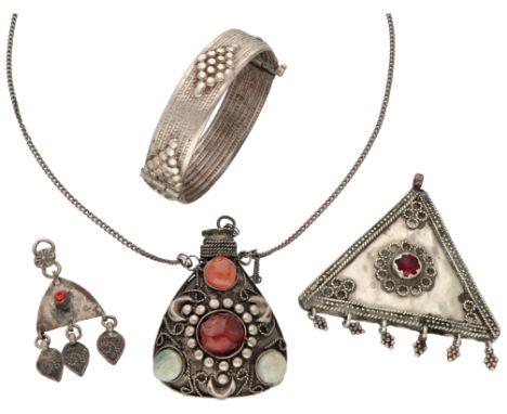 Medicine bottle set with various gemstones, silver bangle and pendants. Bottle set with six rough cut stones (including agate