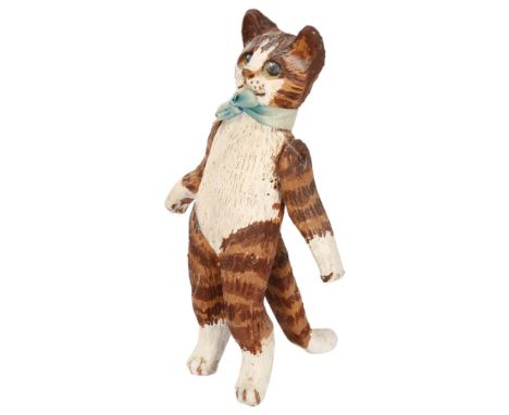 A late 20th century ceramic standing cat, with articulated front legs, unsigned, height 14cmGood condition, no chips, cracks 