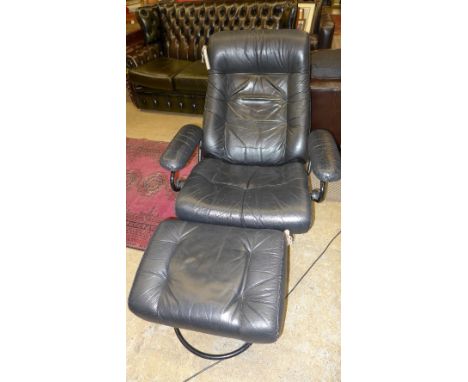 A 1970s vintage reclining black leather easy armchair on ebonised chrome supports , with matching footstall (2)