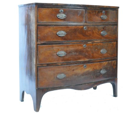 A late 18th Century Georgian mahogany and satinwood bow front chest of drawers. The bow fronted bank of two over three drawer