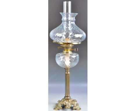 An antique 19th Century Victorian glass and gilded brass oil lamp having a pineapple pattern glass shade with original flume.