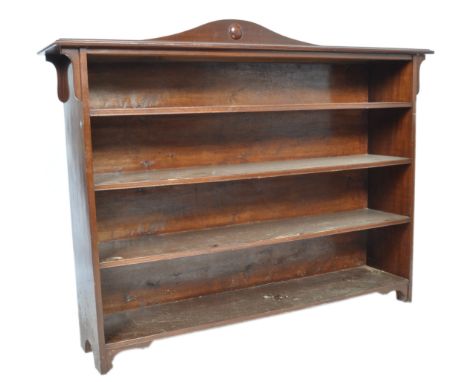 A late 19th / early 20th Century English Arts &amp; Crafts antique mahogany open bookcase comprising of four shelves with arc