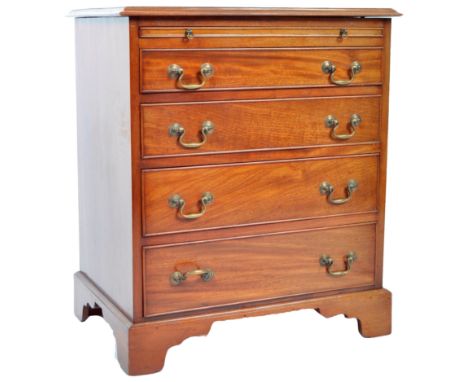 An antique 19th Century Georgian English mahogany Bachelor's chest of drawers having a chamfered edge rectangular top over a 