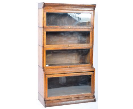 An early 20th Century English antique Globe Wernicke oak stacking lawyers barristers bookcase having four glazed cabinet door