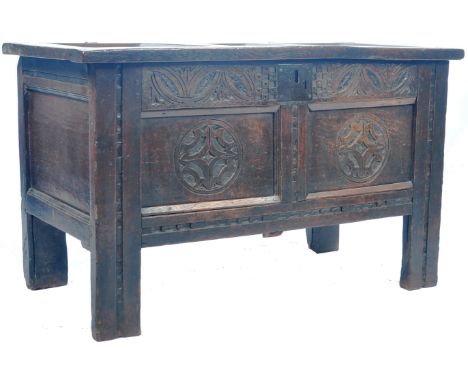 An antique 17th Century English oak coffer blanket box mule chest having a panelled top with original ring hinges opening to 