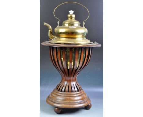 An antique 19th Century Continental brass and copper kettle raised on a mahogany base. The kettle of large rounded form havin