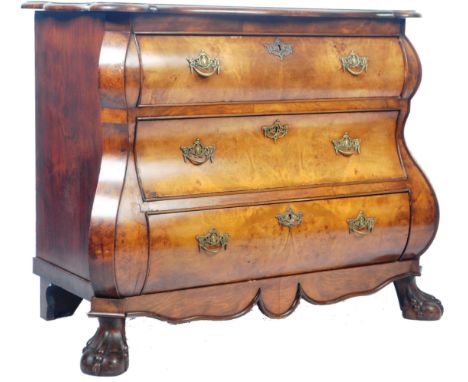 An antique 19th Century walnut commode chest of drawers having serpentine bombe front with a quarter panel veneer top. The gr