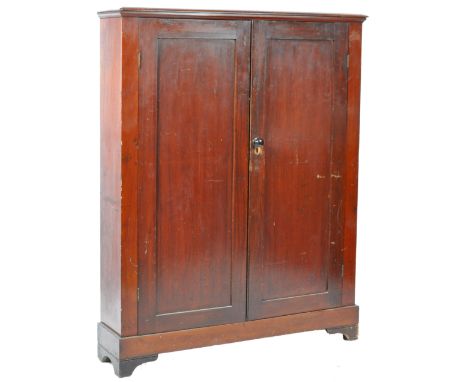 An antique early 19th Century Victorian English mahogany double door estate cupboard / bookcase / storage unit of slender for