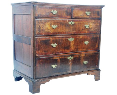 An antique 17th Century Queen Anne walnut and oak chest of drawers. The bank of two over three drawers having fielded panel s