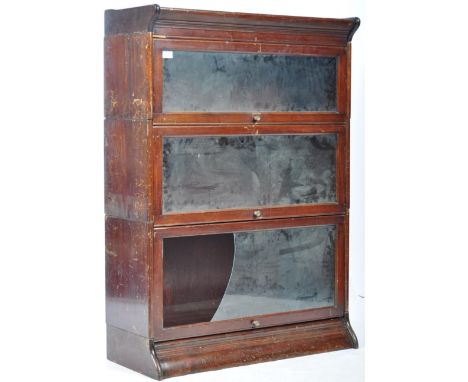 An early 20th Century English antique Globe Wernicke oak stacking lawyers barristers bookcase having three glazed cabinet doo