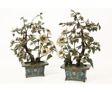 A pair of Chinese hard stone ornaments in the form of trees, each in cloisonne planter, 38cm high