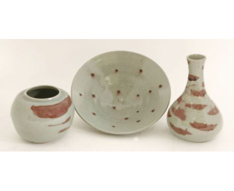 A bowl, by George Cass, with a raspberry spotted glaze, 25.5cm diameter, and two vases, with similar glazes, 12 and 21cm high
