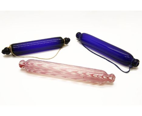 A Thomas Webb blue glass rolling pin, together with a blue glass rolling pin, a Nailsea pink and white swirled rolling pin an