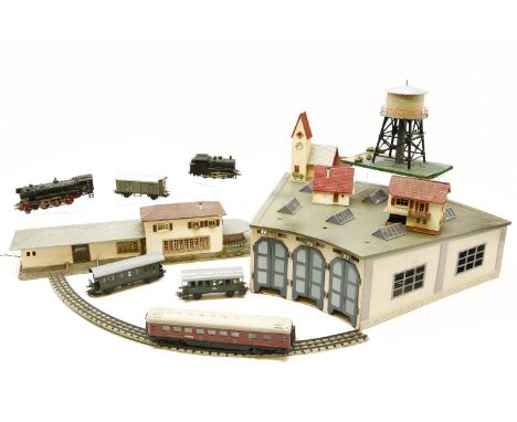 A comprehensive Marklin HO train set, including locomotives, coaches, rolling stock, together with a signal light system, tur