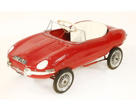 A Tri-ang pedal car model of a Jaguar E-Type, in a red finish