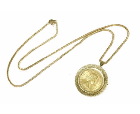 A 1958 sovereign, claw set to a textured bark pendant/brooch, marked 685, suspended on a 9ct fox tail chain, total weight 15.