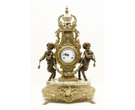 A Continental brass and onyx mantel clock, the white enamel dial with black Roman numerals and bell strike movement, flanked 