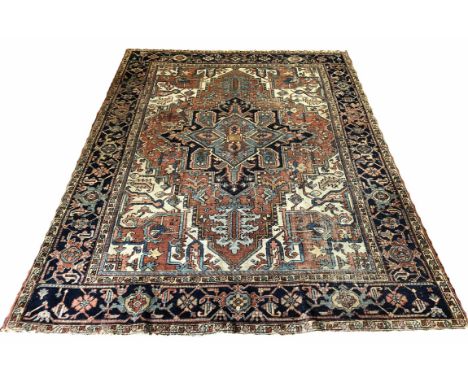 ANTIQUE HERIZ CARPET, 281cm x 211cm, central medallion on a terracotta palmette and vine field, within corresponding spandrel