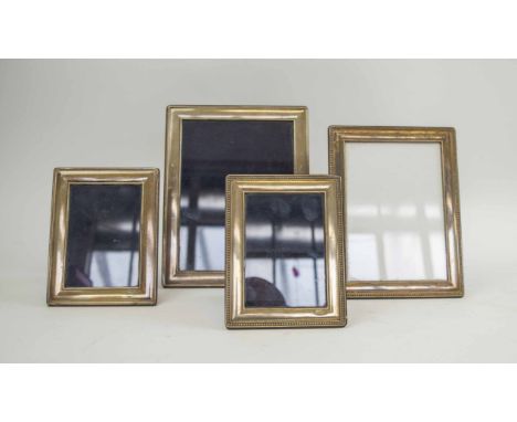 FOUR SILVER EASEL PHOTOGRAPH FRAMES, largest 23.5cm H x 18.5cm. (4)